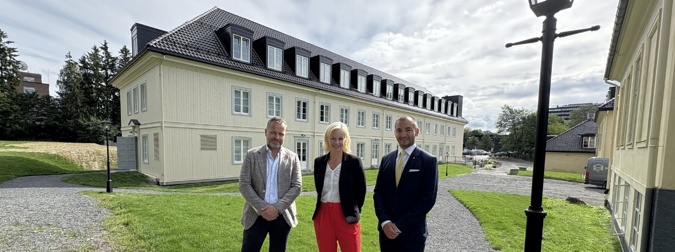 Tre personer foran det nye bygget Nordfløyen på Blindern.