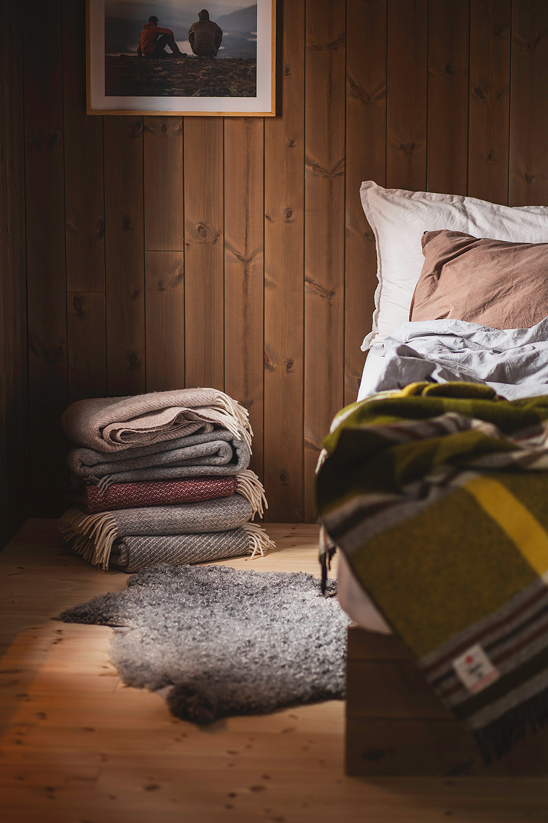 Naturmaterial som linne och ull kompletterar träpanelen.