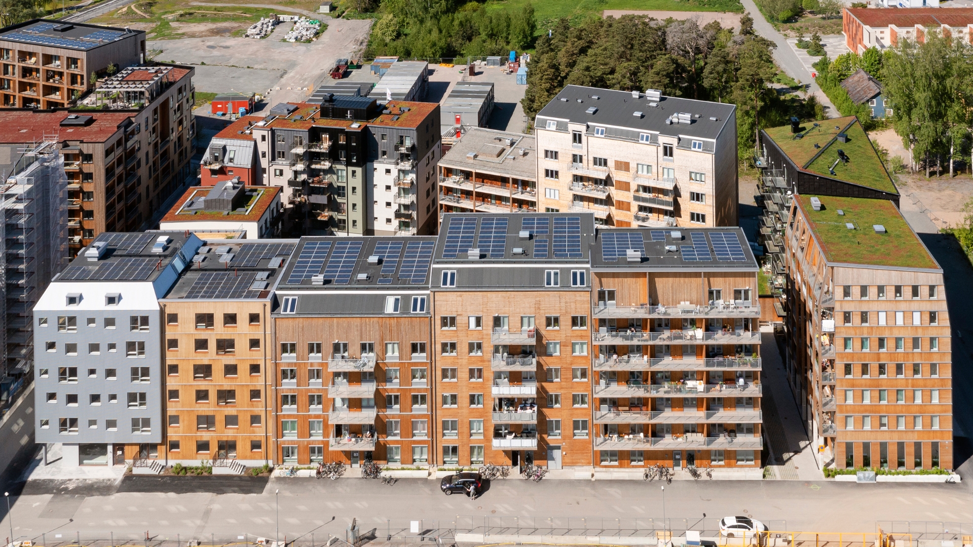 Flerbostadshus med fasad av naturlig ThermoWood och cederträ.